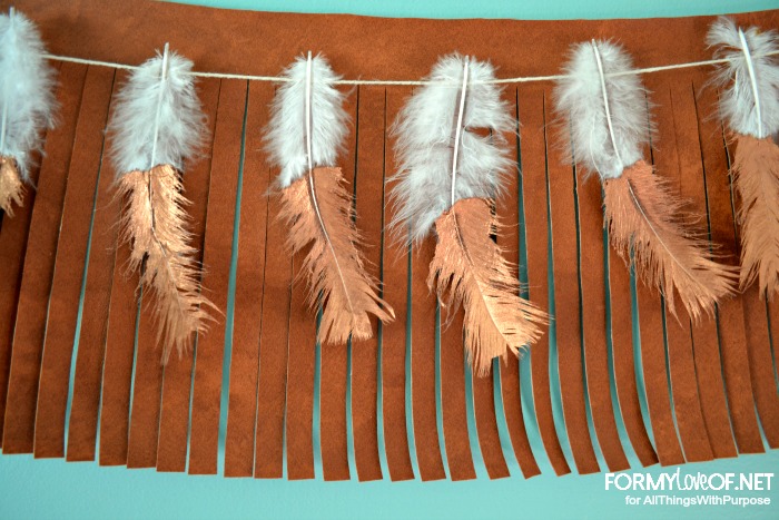 Copper Dipped Feather Banner hanging atop leather fringe banner